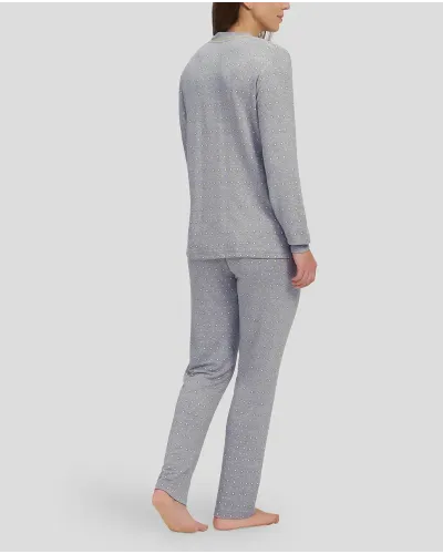 Woman in grey winter pyjamas with diamond pattern with cuffs and V-neck collar