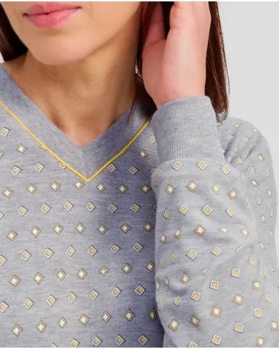 Woman in grey winter pyjamas with diamond pattern with cuffs and V-neck collar