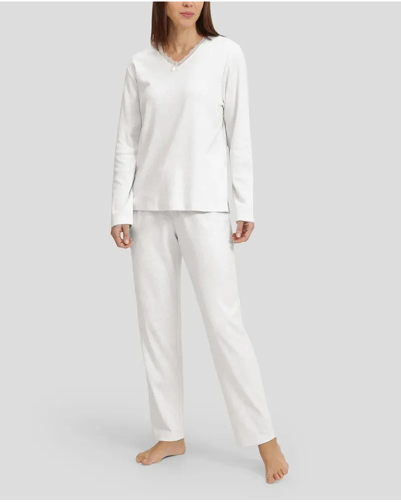 Woman in ivory winter lingerie pyjamas with V-neck and lace