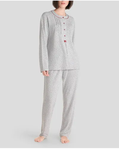 Woman in grey long winter pyjamas with closed collar with maroon flowers