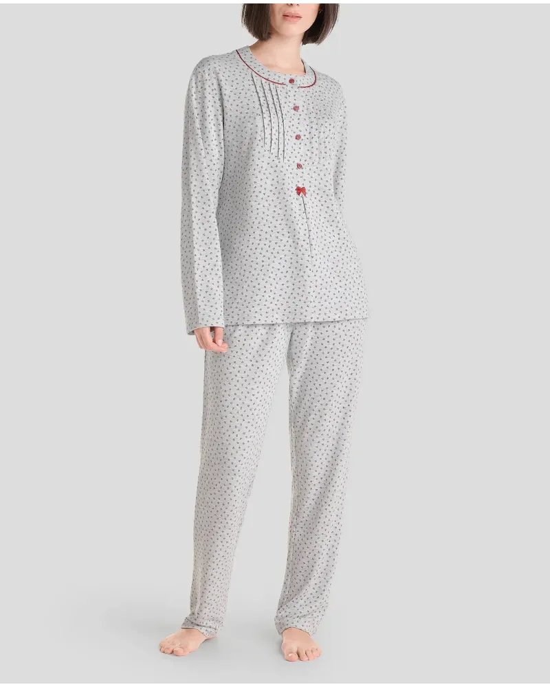 Woman in grey long winter pyjamas with closed collar with maroon flowers