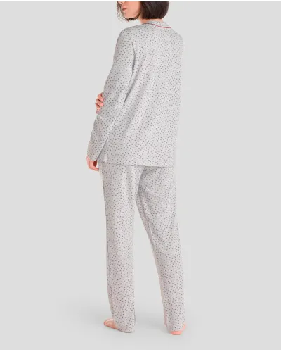 Woman in grey long winter pyjamas with closed collar with maroon flowers