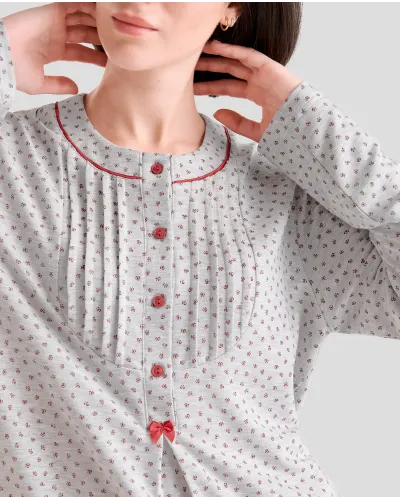 Woman in grey long winter pyjamas with closed collar with maroon flowers