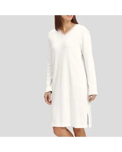Woman in ivory long-sleeved winter lingerie nightdress with V-neck and lace collar