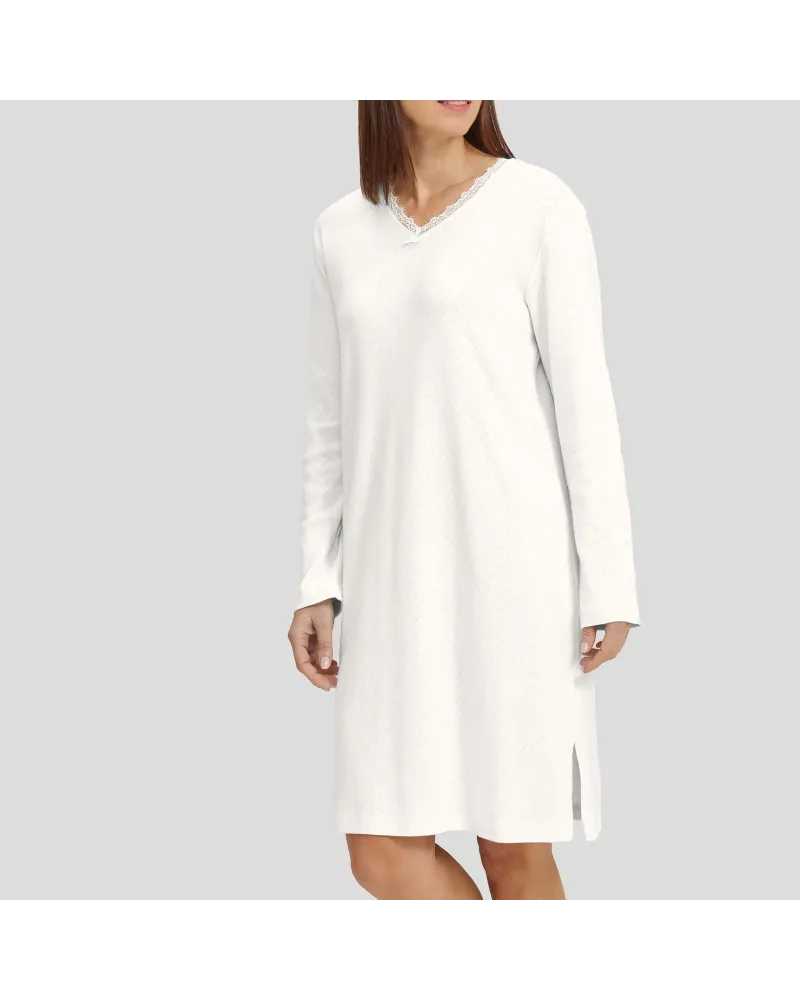Woman in ivory long-sleeved winter lingerie nightdress with V-neck and lace collar