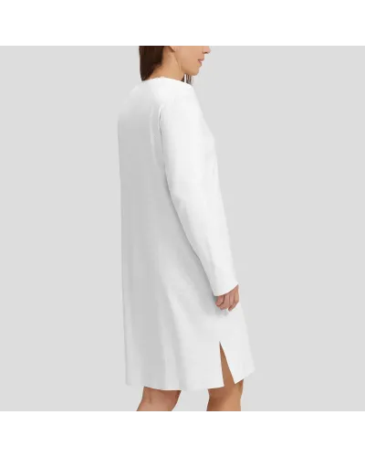 Woman in ivory long-sleeved winter lingerie nightdress with V-neck and lace collar