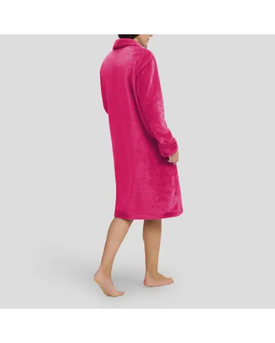 Woman in fuchsia flannel long dressing gown, buttoned and with pockets for winter