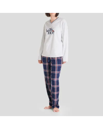 Woman in long Christmas pyjamas with plain embroidered V-neck top and matching navy checked trousers.