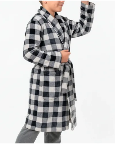 Boy wearing a black and white checked winter dressing gown over grey velvet pyjamas