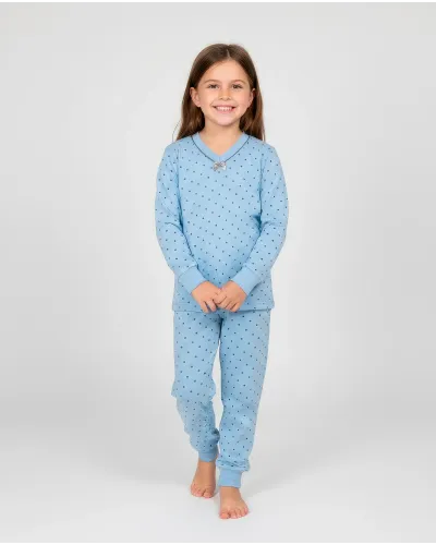 Girl wearing comfortable long winter pyjamas with a small grey polka dot pattern, V-neck with bow.