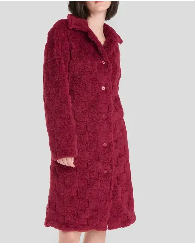 Woman in short red buttoned winter coat with side pockets.