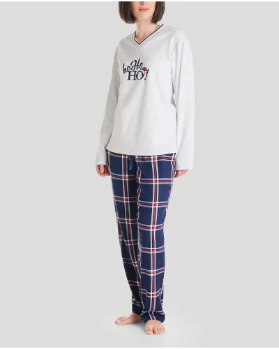 Woman in long Christmas pyjamas with plain embroidered V-neck top and matching navy checked trousers.