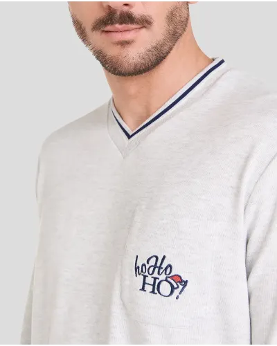 Man in long-sleeved Christmas pyjamas with checked trousers