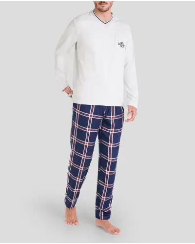 Man in long-sleeved Christmas pyjamas with checked trousers