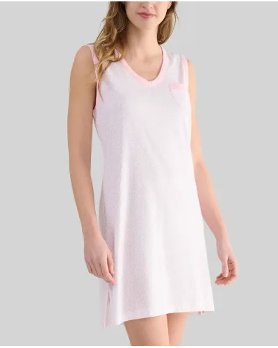 A woman with her back turned wears a light-coloured sleeveless summer camisole with delicate prints of light blue hearts.