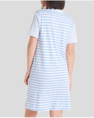 Woman wears short-sleeved summer nightgown in elegant light blue stripes and an open collar