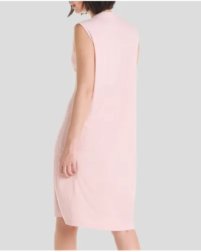 Woman wears sleeveless lingerie summer nightdress in pink ribbed lingerie for summer with open neckline and back