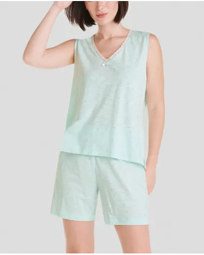 Woman poses with short sleeveless summer pyjamas in cool green soft modal cotton fabric