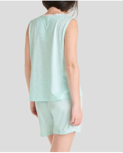 Woman poses with short sleeveless summer pyjamas in cool green soft modal cotton fabric