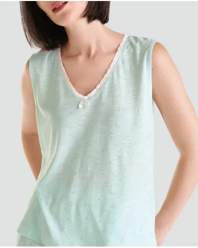Woman poses with short sleeveless summer pyjamas in cool green soft modal cotton fabric