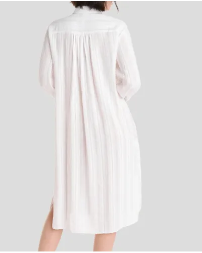 Mujer luce vestido largo abotonado color blanco con cuello camisero y sombrero de paja