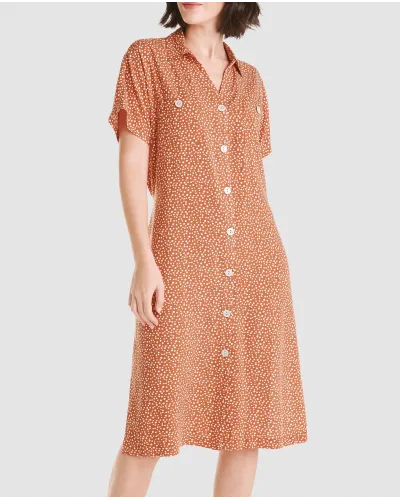 Woman in a short open summer dress with short sleeves in orange with polka dot pattern