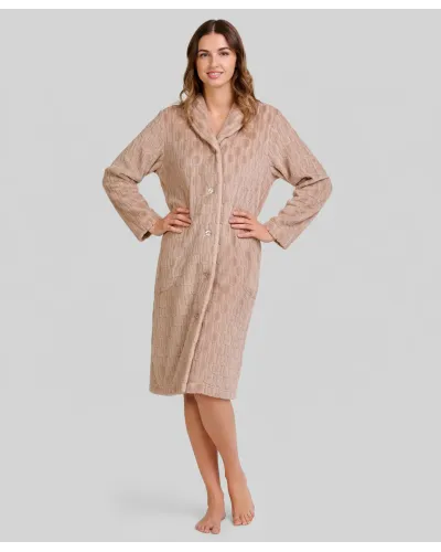 Woman poses in an elegant, knee-length, camel-coloured buttoned robe.