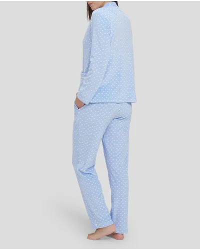 Woman in light blue winter pyjamas with little hearts