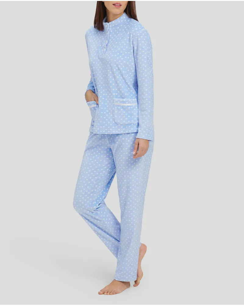 Woman in light blue winter pyjamas with little hearts