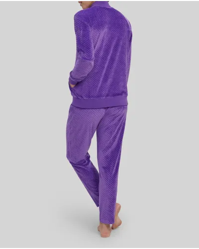 Woman wears comfortable purple tracksuit with zips