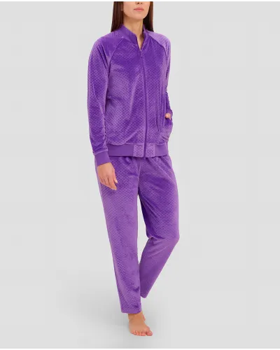 Woman wears comfortable purple tracksuit with zips
