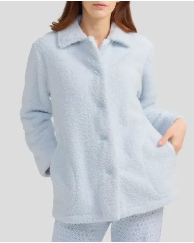 Woman with short light blue sheepskin coat with buttons and pockets
