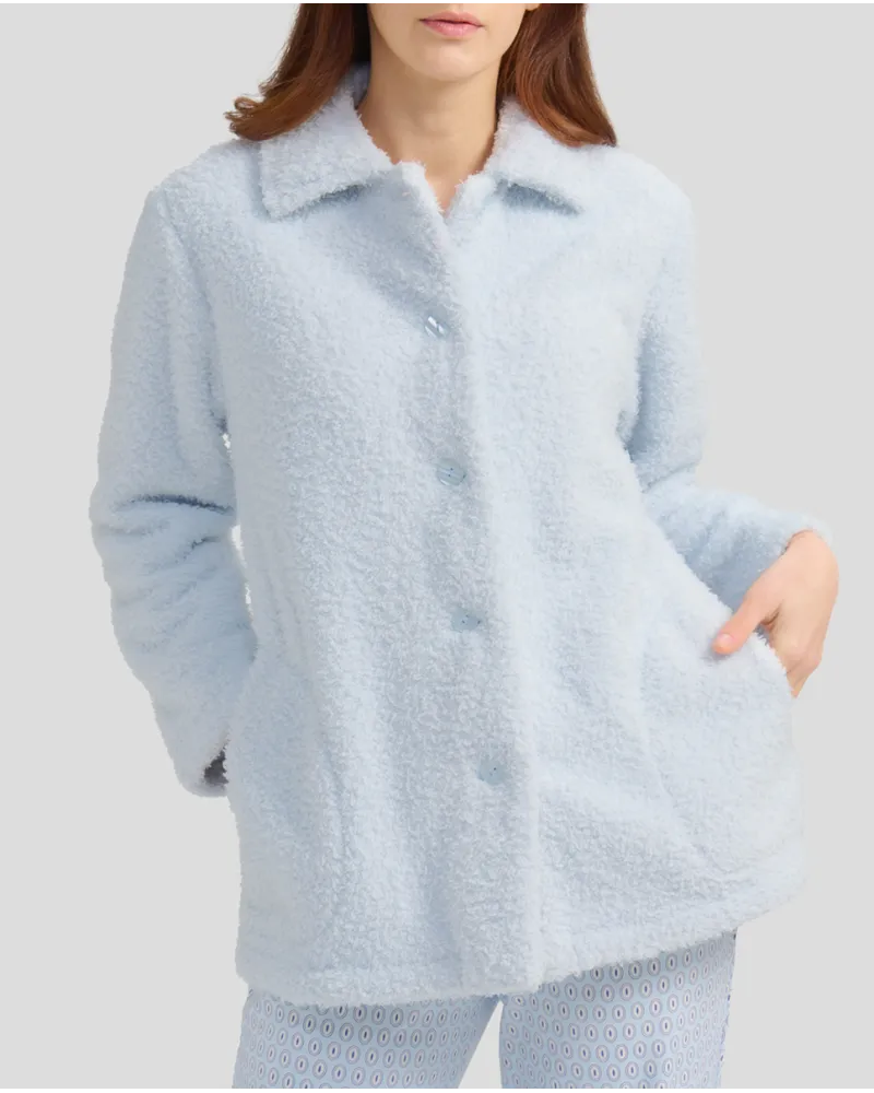Woman with short light blue sheepskin coat with buttons and pockets
