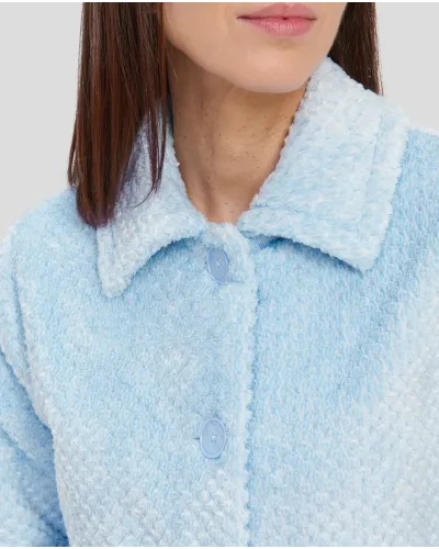 Woman in short light blue buttoned dressing gown with side pockets