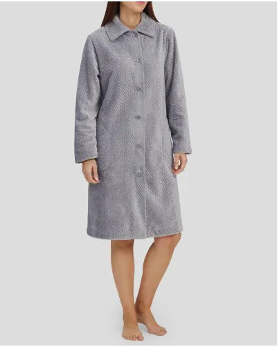 Woman in grey long winter coat, buttoned and with side pockets