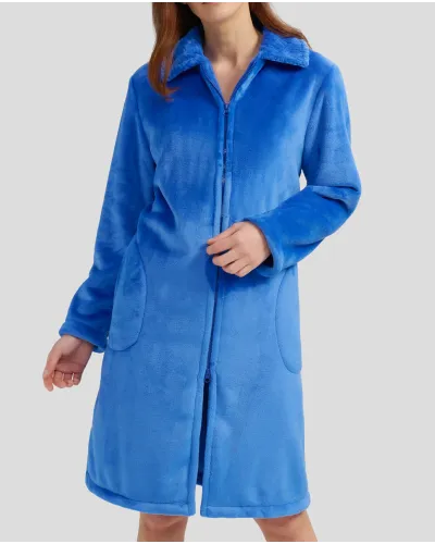 Woman in long blue winter dressing gown with zip and pockets