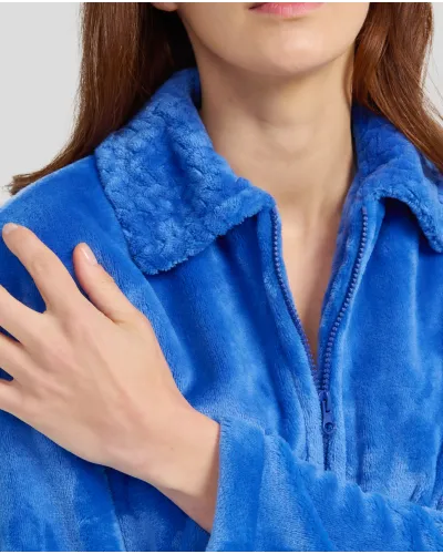 Woman in long blue winter dressing gown with zip and pockets