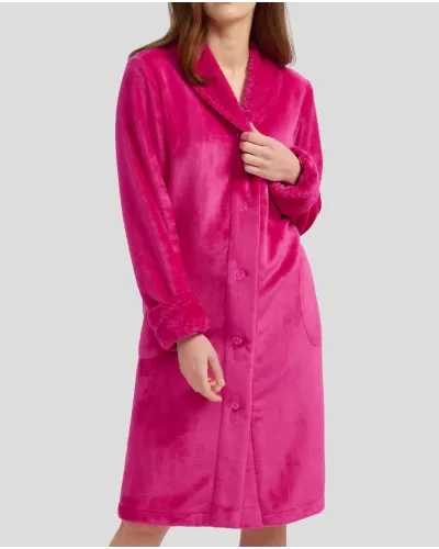Woman in fuchsia flannel long dressing gown, buttoned and with pockets for winter