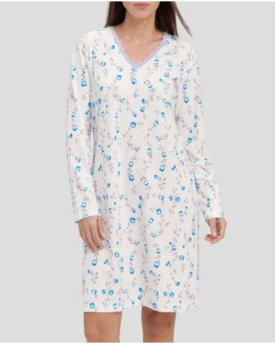 Woman with light blue flowered winter nightdress with lace collar