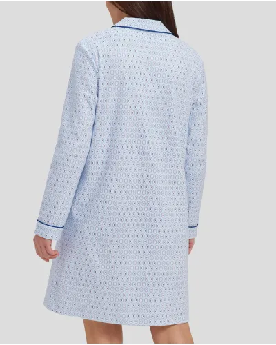 Woman in light blue oval winter long nightdress with open collar with blue buttons and piping