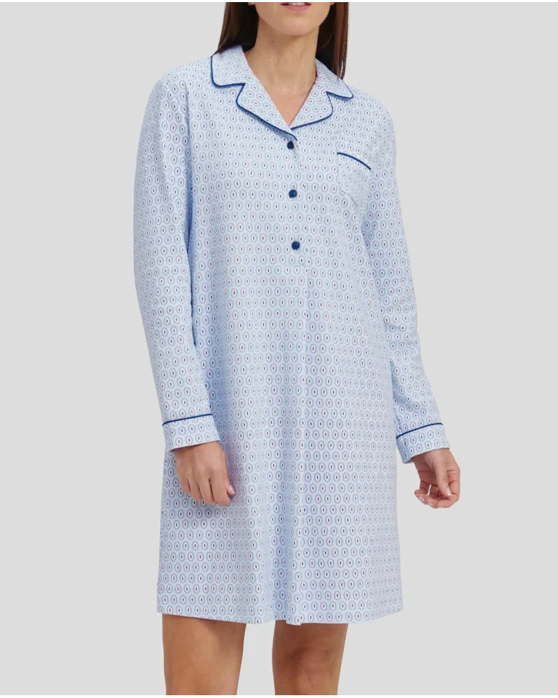 Woman in light blue oval winter long nightdress with open collar with blue buttons and piping