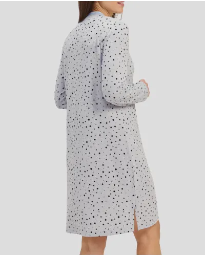 Woman in a grey winter nightdress with polka dots and cuffs