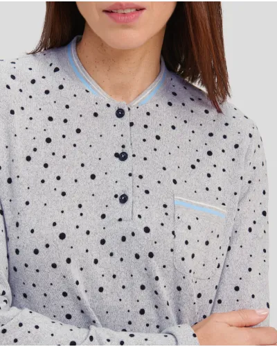 Woman in a grey winter nightdress with polka dots and cuffs