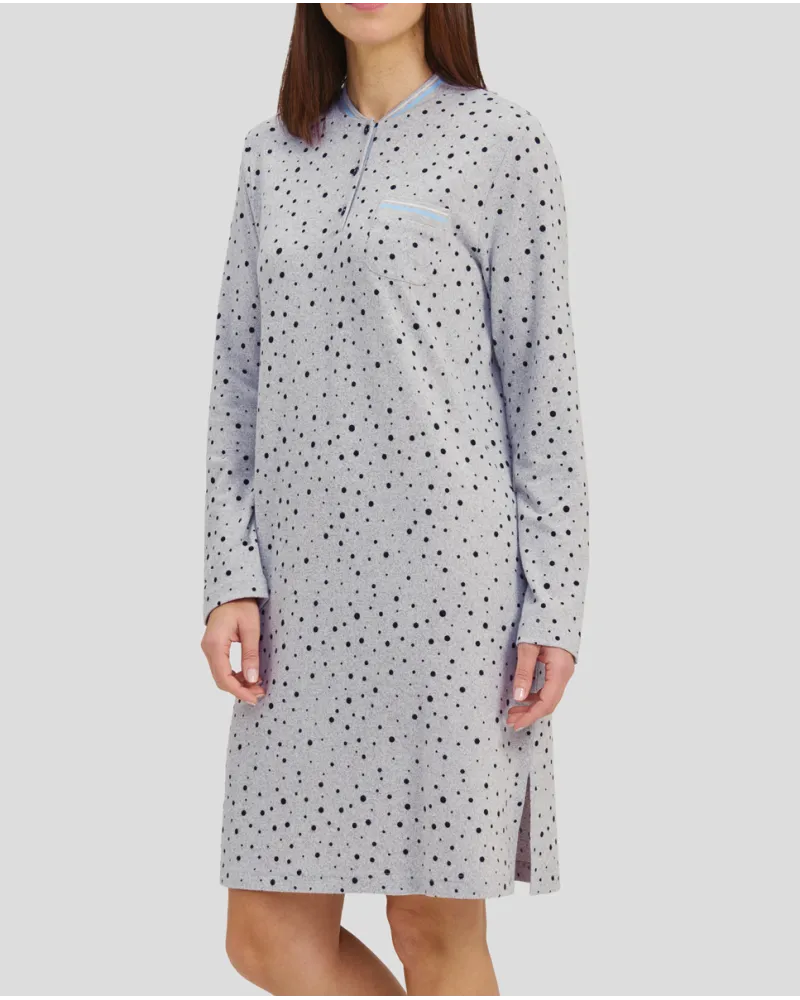 Woman in a grey winter nightdress with polka dots and cuffs