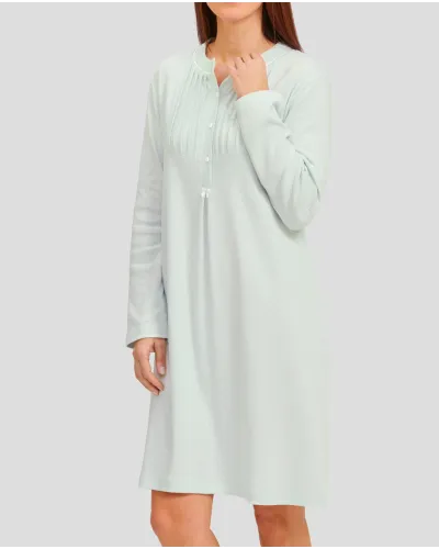 Woman in soft green long-sleeved nightgown for winter with louvers