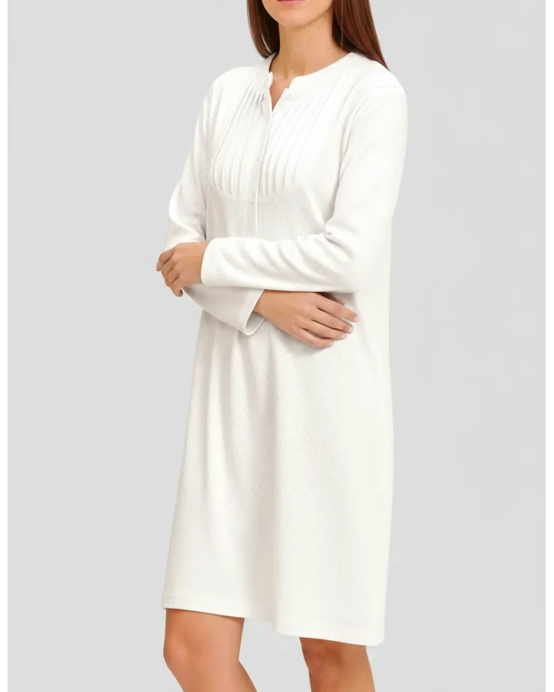Woman in ivory long-sleeved nightgown for winter with louvres