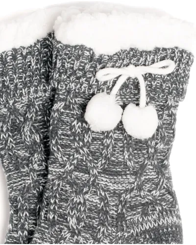 Woman enjoying grey braided slipper socks with sheepskin lining