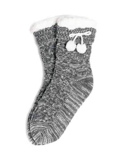 Woman enjoying grey braided slipper socks with sheepskin lining