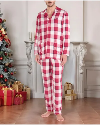 Man poses in red plaid Christmas pyjamas with long Christmas pyjamas