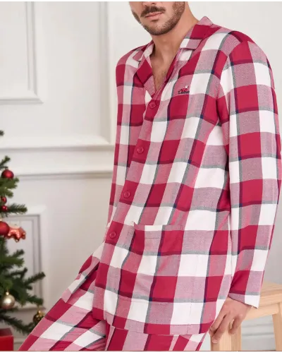 Man poses in red plaid Christmas pyjamas with long Christmas pyjamas